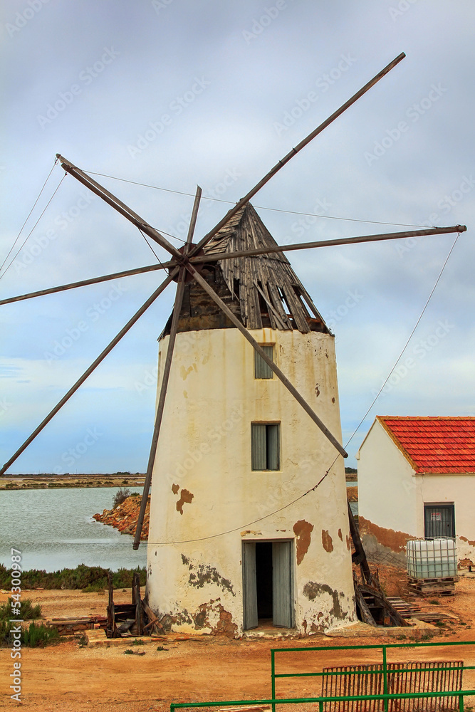 old Windmill XVI century white stone and wood