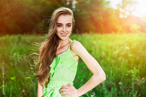 Happy beautiful summer woman posing in the meadow outdoors
