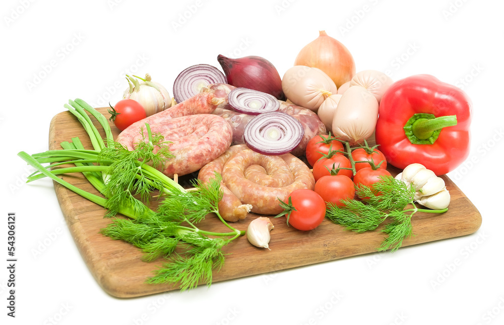sausage and vegetables on a cutting board on a white background sausage and vegetables on a cutting board on a white background