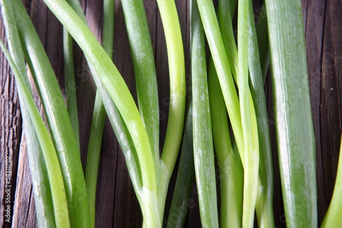 Spring onion on wooden board 