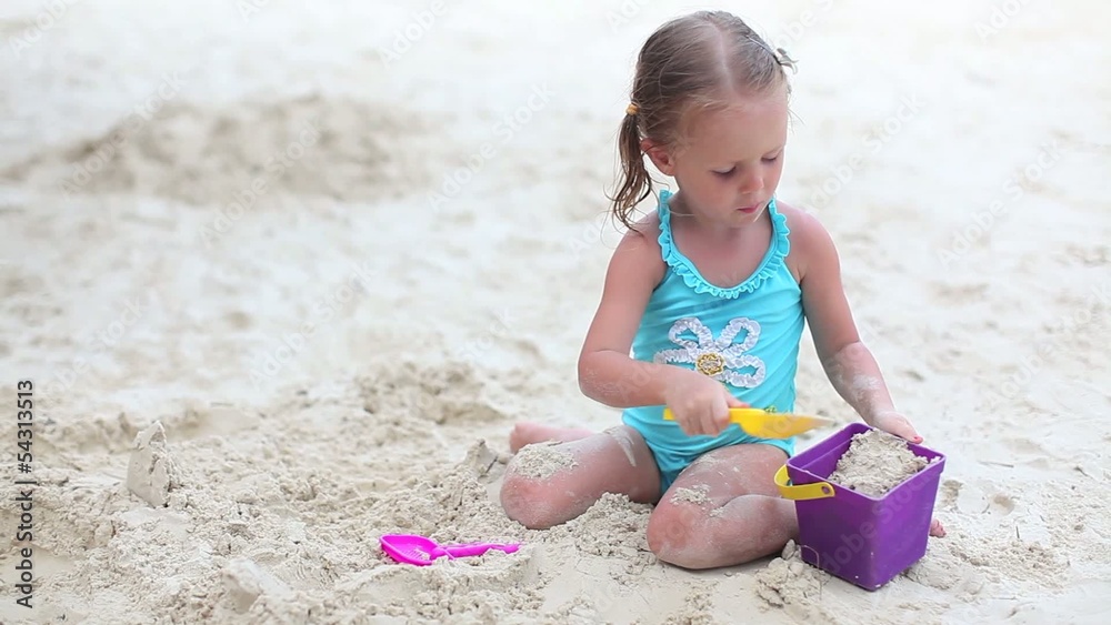 Beautiful little girl playing on tropical beach Beautiful little girl playing on tropical beach