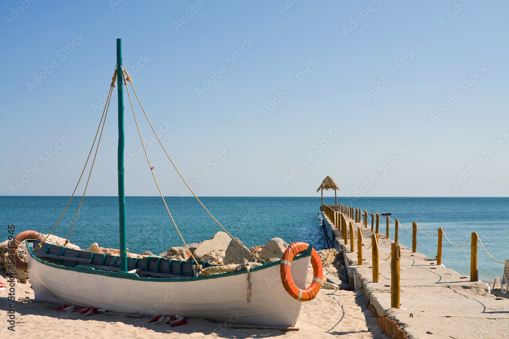 Boat on the beach at sunrise time Boat on the beach at sunrise time