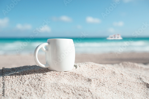 white espresso coffee cup with ocean , beach and seascape