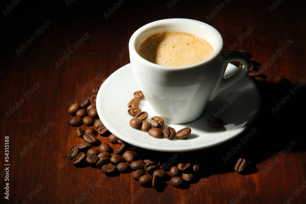 Cup of coffee with coffee beans on wooden background Cup of coffee with coffee beans on wooden background