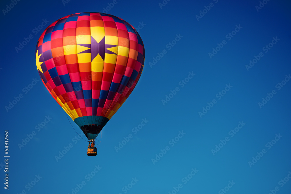 Brightly colored hot air balloon with a sky blue background Brightly colored hot air balloon with a sky blue background