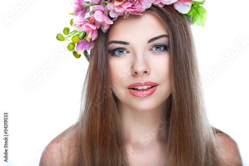 Hortrait of beautiful young girl with pink flowers