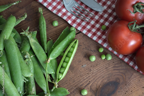 Pea pods in a bowl on wooden Table photo