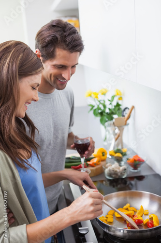 Couple cooking together vegetables © WavebreakmediaMicro