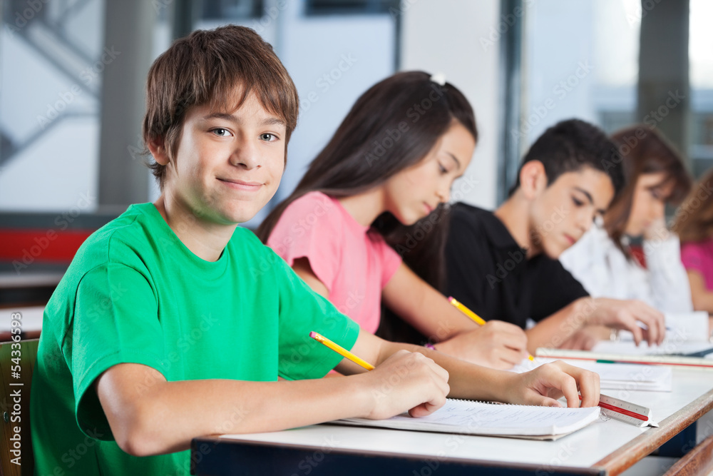 Teenage Boy With Friends Studying At Desk Teenage Boy With Friends Studying At Desk