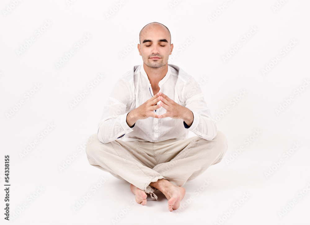 Man dressed in white sitting relaxing and doing yoga. Man dressed in white sitting relaxing and doing yoga.
