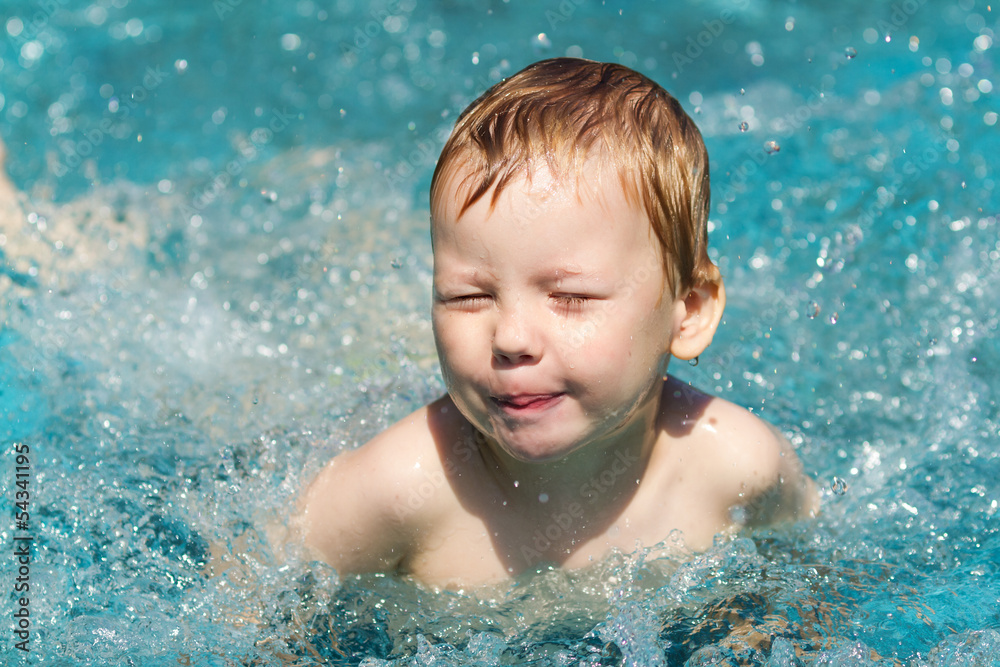 Three years old boy in swimming pool