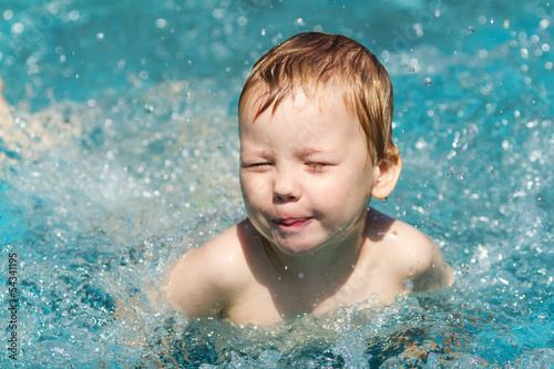 Three years old boy in swimming pool
