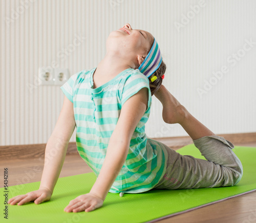 little girl doing gymnastic exercises © tan4ikk
