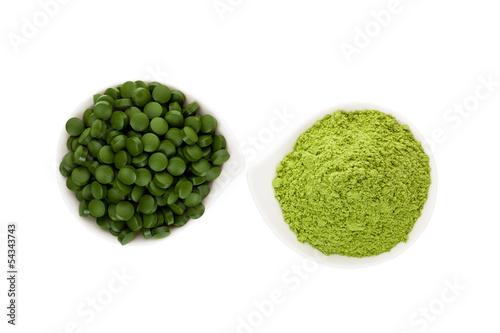 Healthy living. Spirulina pills and wheatgrass. photo