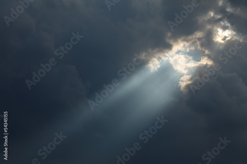 Canvas Print stormy sky with a dramatic sunbeam