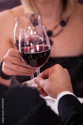 Close-up Of Couple Toasting Wine