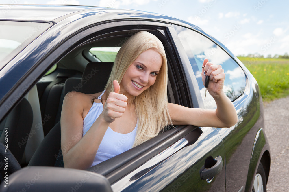 Happy Woman In A Car Showing A Key