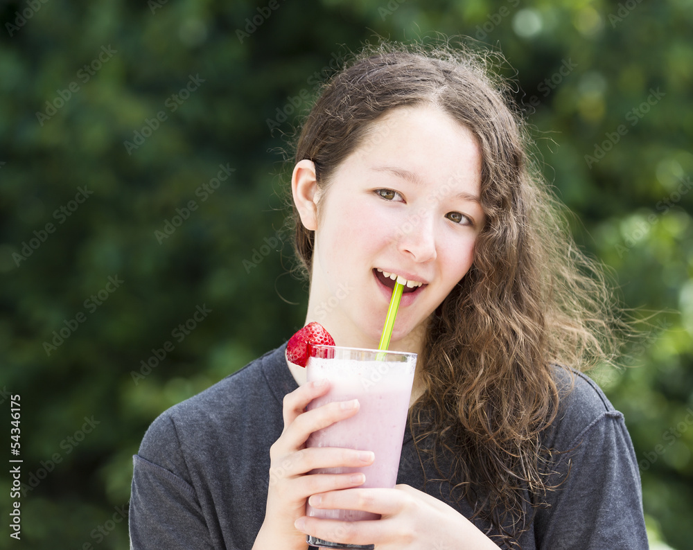 Happy young girl drinking milkshake outdoors in the daytime Happy young girl drinking milkshake outdoors in the daytime