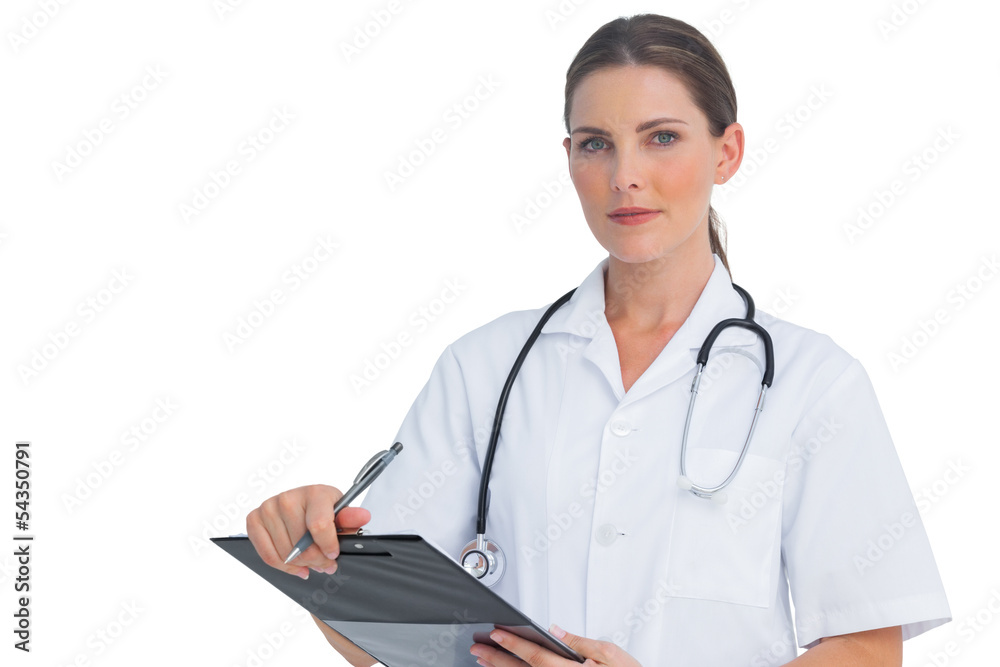 Nurse holding clipboard and looking at camera Nurse holding clipboard and looking at camera