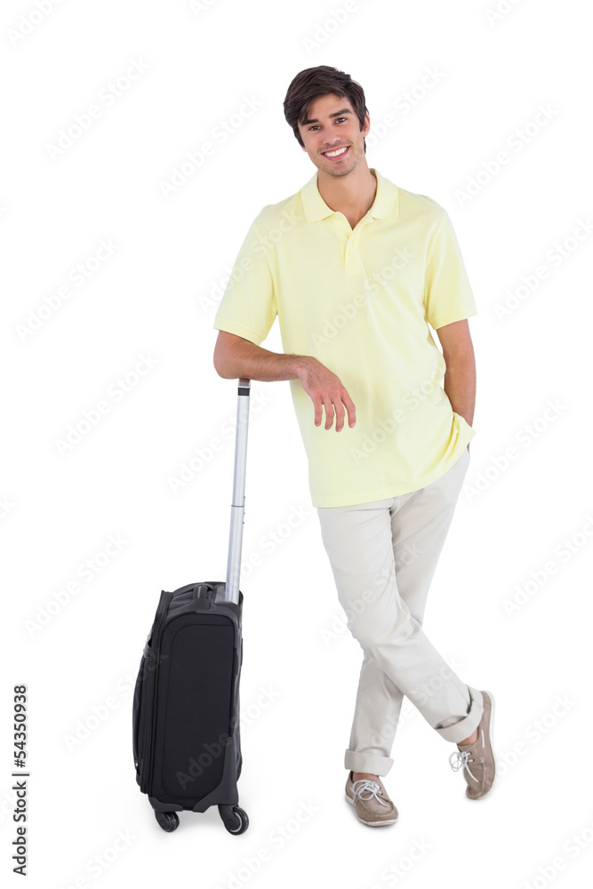 Smiling man standing with his suitcase Smiling man standing with his suitcase