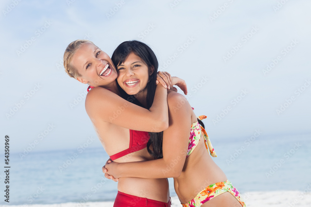 Friends hugging and smiling at camera