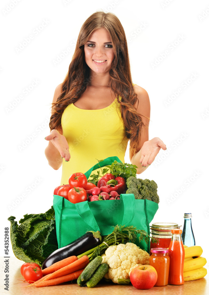 Young woman with variety of grocery products in shopping bag Young woman with variety of grocery products in shopping bag