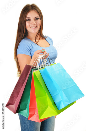 Young happy woman with colorful paper shopping bags isolated
