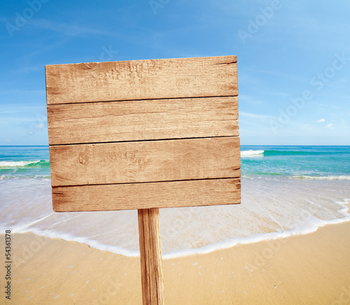 wood road sign on sea beach