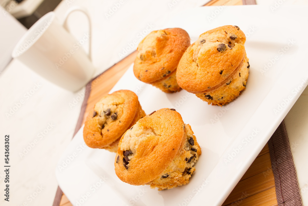 Vanilla with chocolate chips Muffins with a cup of coffee Vanilla with chocolate chips Muffins with a cup of coffee