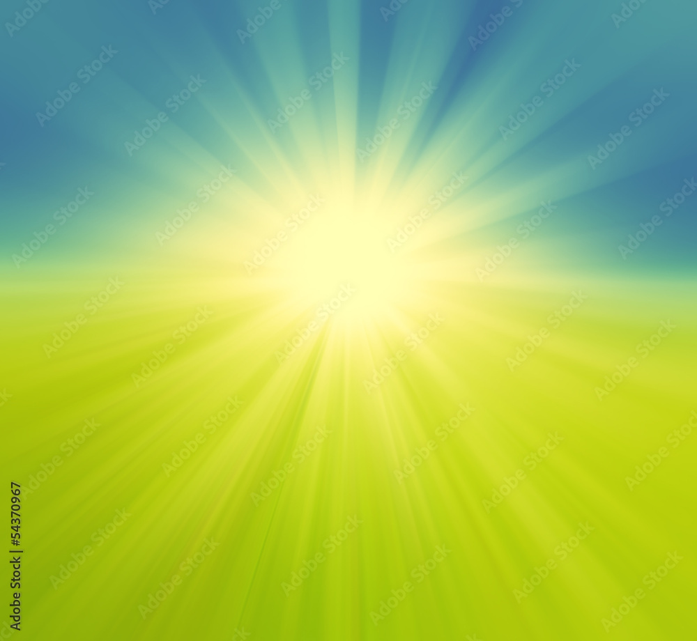 Blurry green field and blue sky with summer sun burst Blurry green field and blue sky with summer sun burst