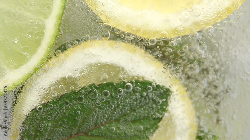 Macro shot of pouring lemonade in glass.