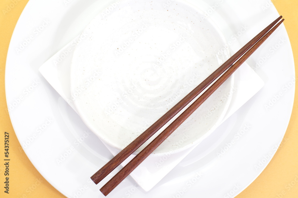 Empty white plate with chopsticks