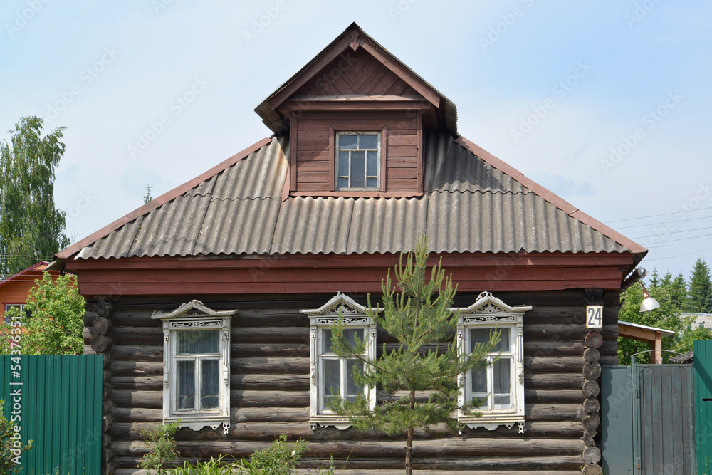 Old log house with carved platbands Old log house with carved platbands