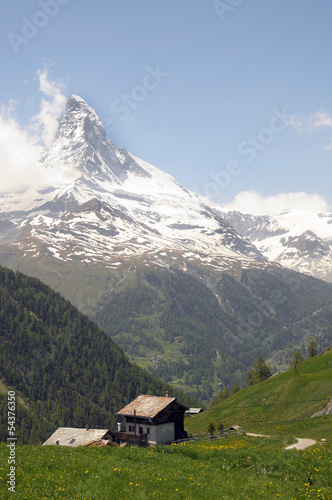 Chalets in pasture beneath the Matterhorn in the Swiss Alps