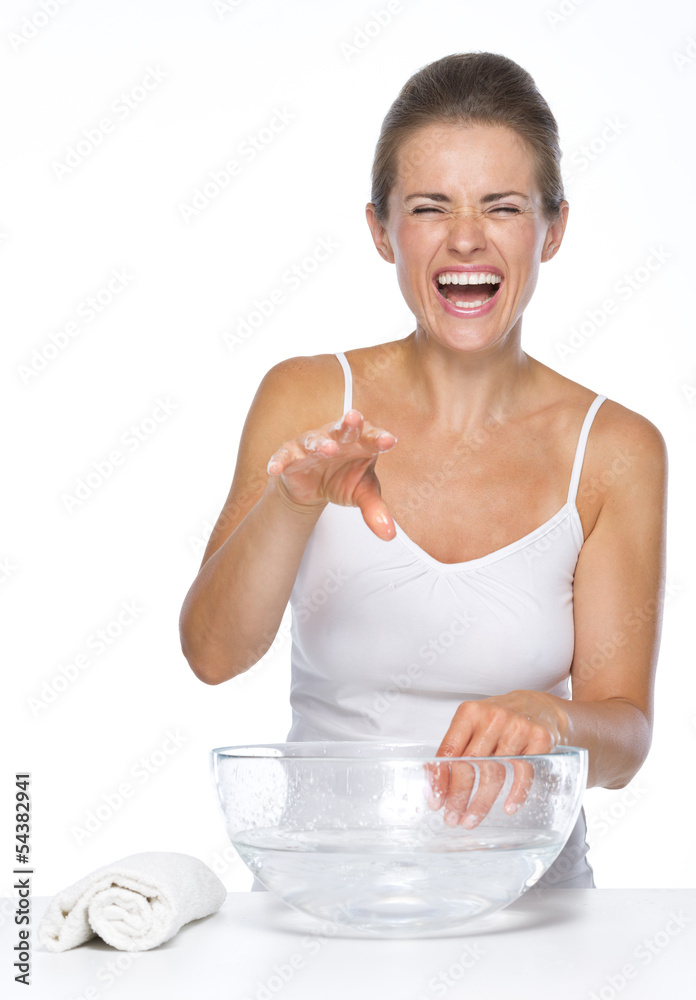 Woman making fun while washing hands in glass bowl with water Woman making fun while washing hands in glass bowl with water