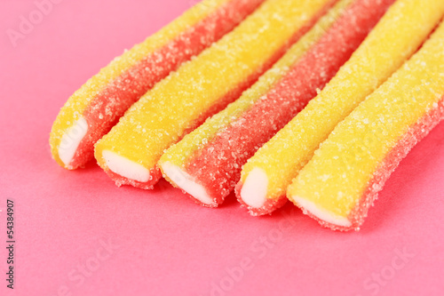 Sweet jelly candies on pink background