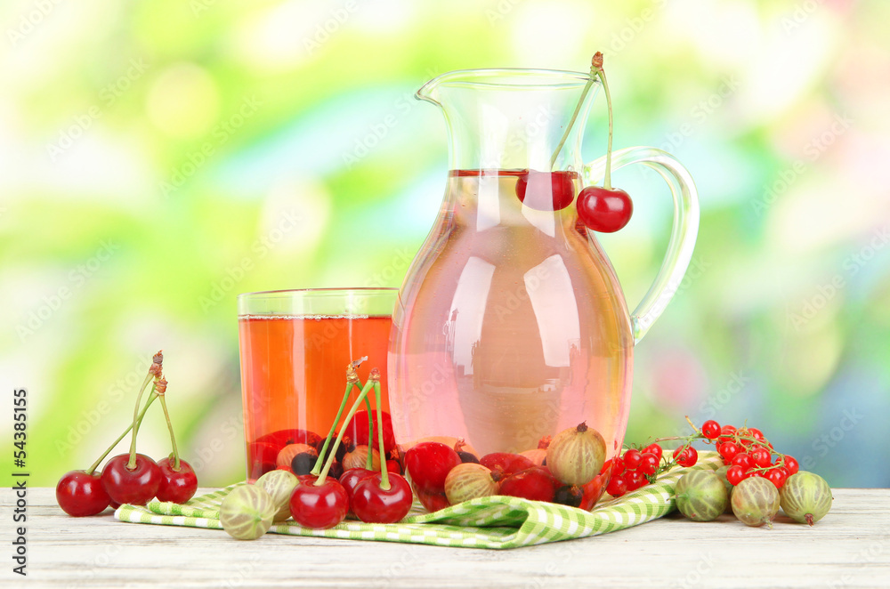 Pitcher and glass of compote with summer berries Pitcher and glass of compote with summer berries