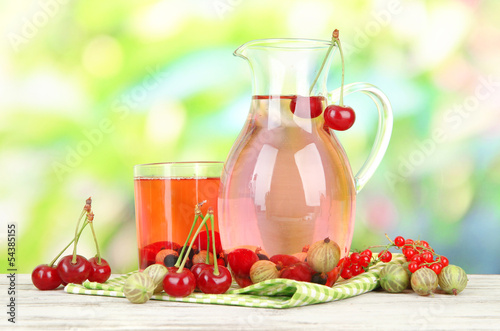 Pitcher and glass of compote with summer berries