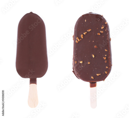 Two chocolate-coated blocks of ice cream on stick.
