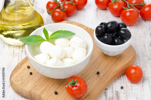 fresh mozzarella in a bowl, olives and cherry tomatoes