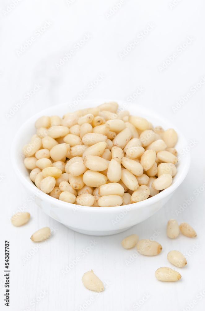 pine nuts in a bowl, vertical