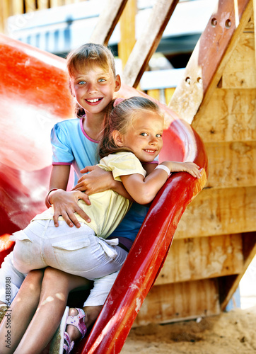 Children move out to slide in playground © Gennadiy Poznyakov