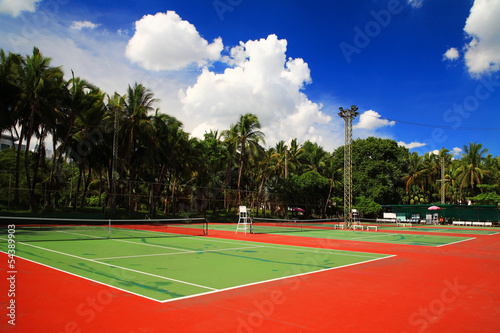 Outdoor tennis hard courts against blue sky © Blanscape