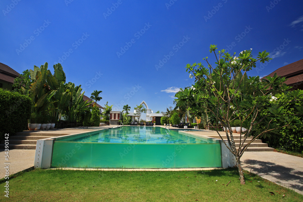 swimming pool against blue sky at luxury resort