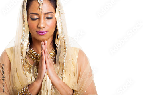 indian woman praying with eyes closed