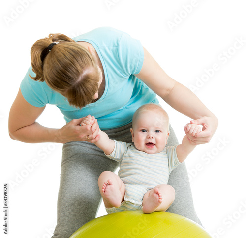 mother playing with baby on...