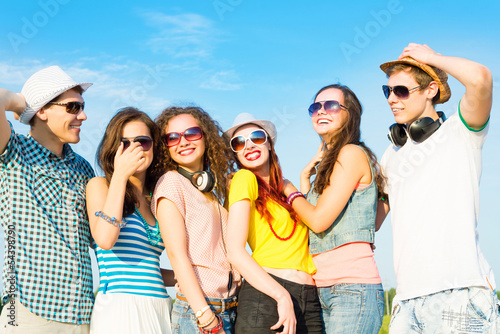 group of young people wearing sunglasses and hat © adam121