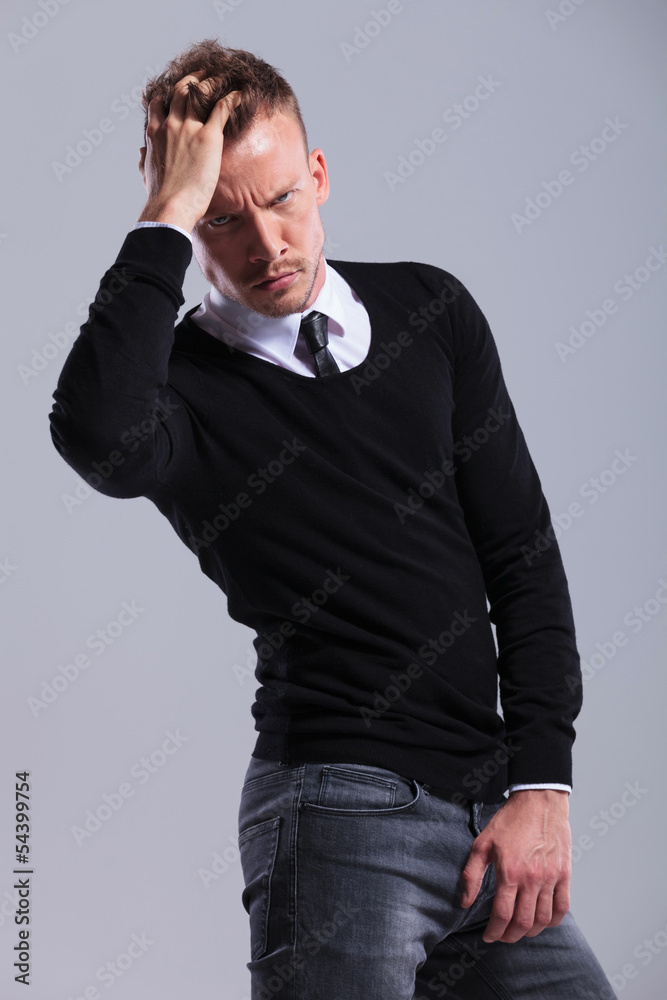 casual man passes his hand through his hair casual man passes his hand through his hair