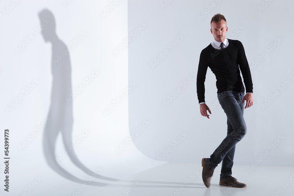 Fototapeta premium casual man poses with a bent leg