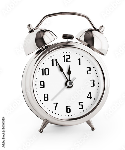 Silver alarm clock showing twelve hours with clipping path with